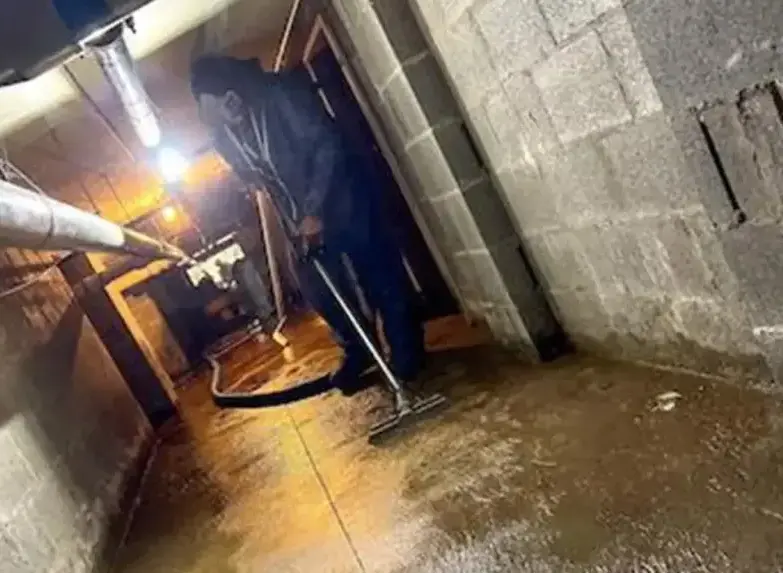 Extraction wand pulling water from a flooded basement after a sump pump failure